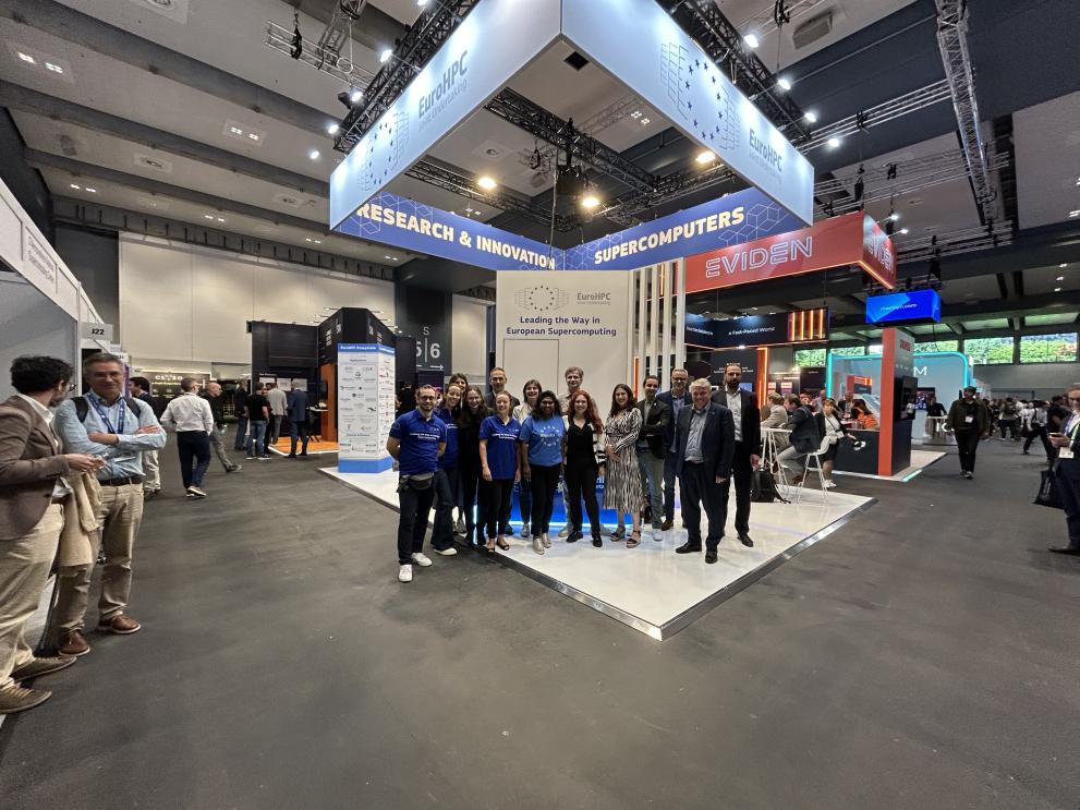  EuroHPC colleagues stanidng in fron of the  EuroHPC booth 